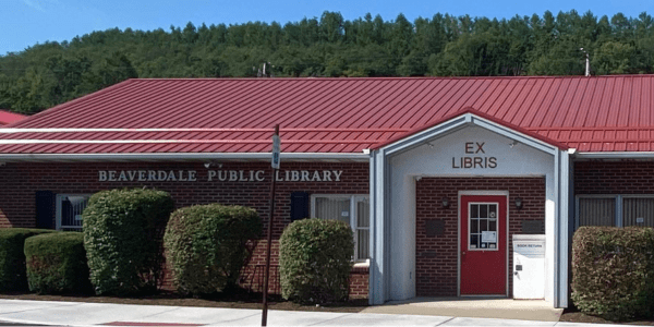 Beaverdale library has a red roof, door, and black shutters.