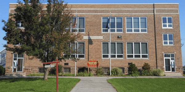 Beaverdale library has a red roof, door, and black shutters.