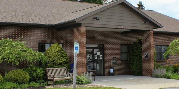 Beaverdale library has a red roof, door, and black shutters.