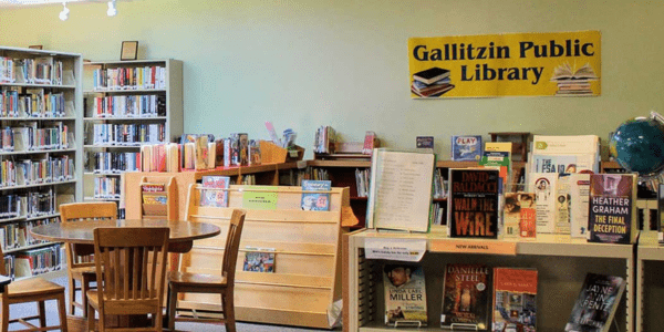 Beaverdale library has a red roof, door, and black shutters.
