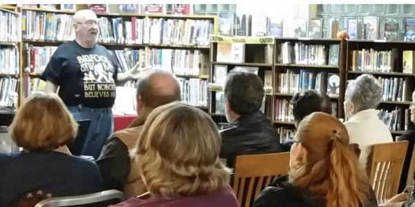 Beaverdale library has a red roof, door, and black shutters.